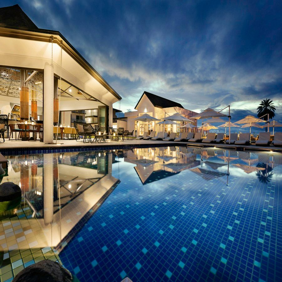 Sunlit pool surrounded by palms